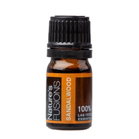 Sandalwood essential oil dropper and fresh cedarwoods in a calming zen setting