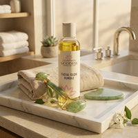 Clerina Facial Glow Bundle containing Organic Oil, Jade Roller and Gua Sha Stone on marble tray